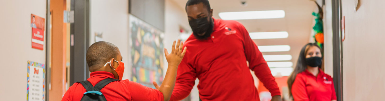 Kid giving teacher high five